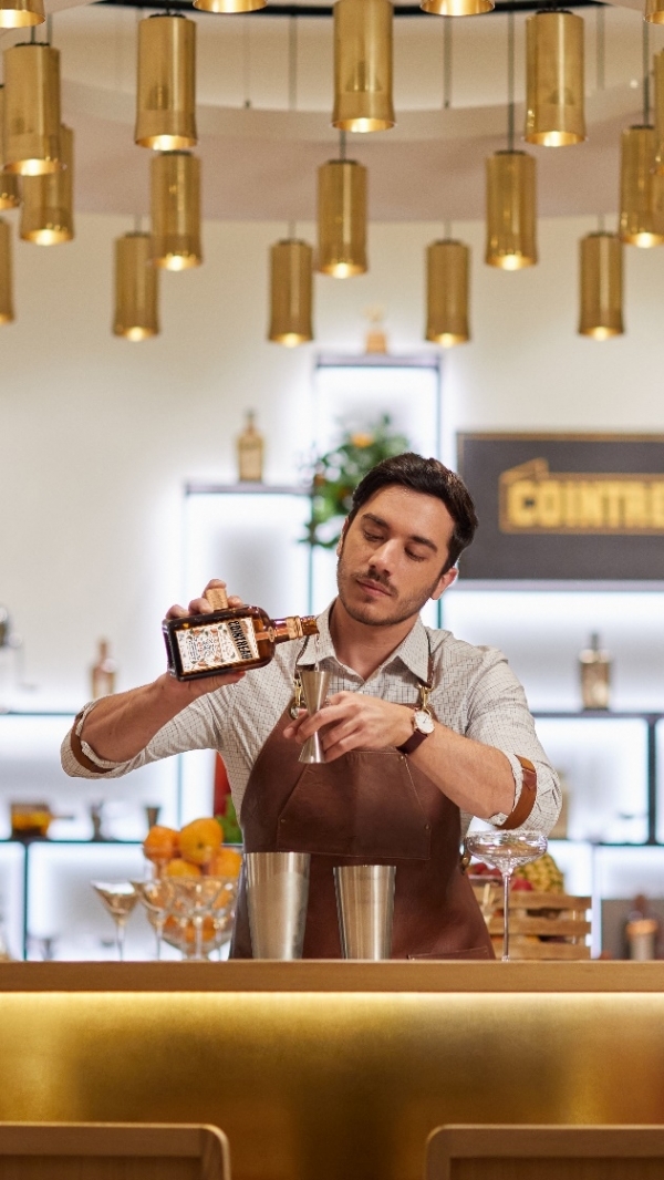 A person pouring a drink into a glass

AI-generated content may be incorrect.